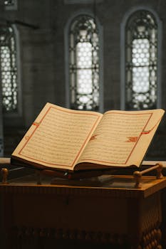 An open Quran on a wooden stand captures spiritual essence in a mosque.
